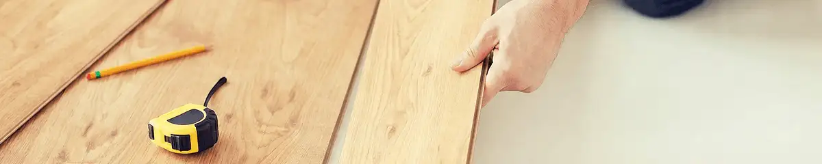 A professional installing wood flooring in Cambridge, MA