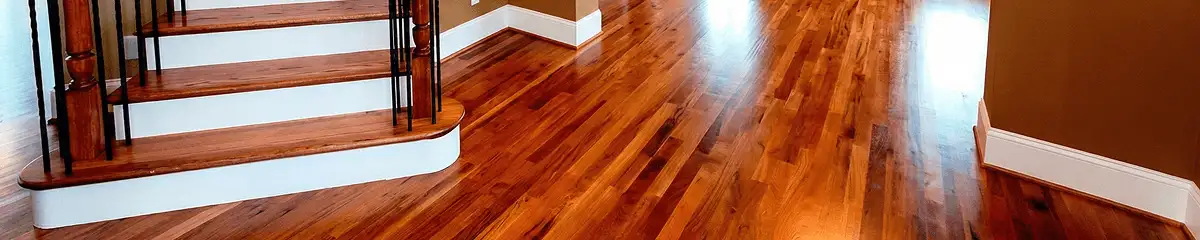 Base floor of a staircase with professionally restored wood flooring in Cambridge MA