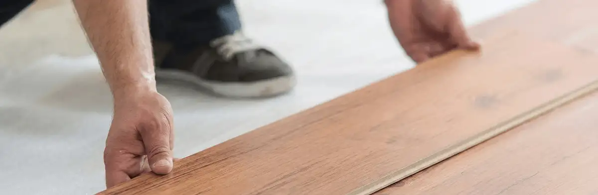 A professional installing laminate flooring in Cambridge, MA